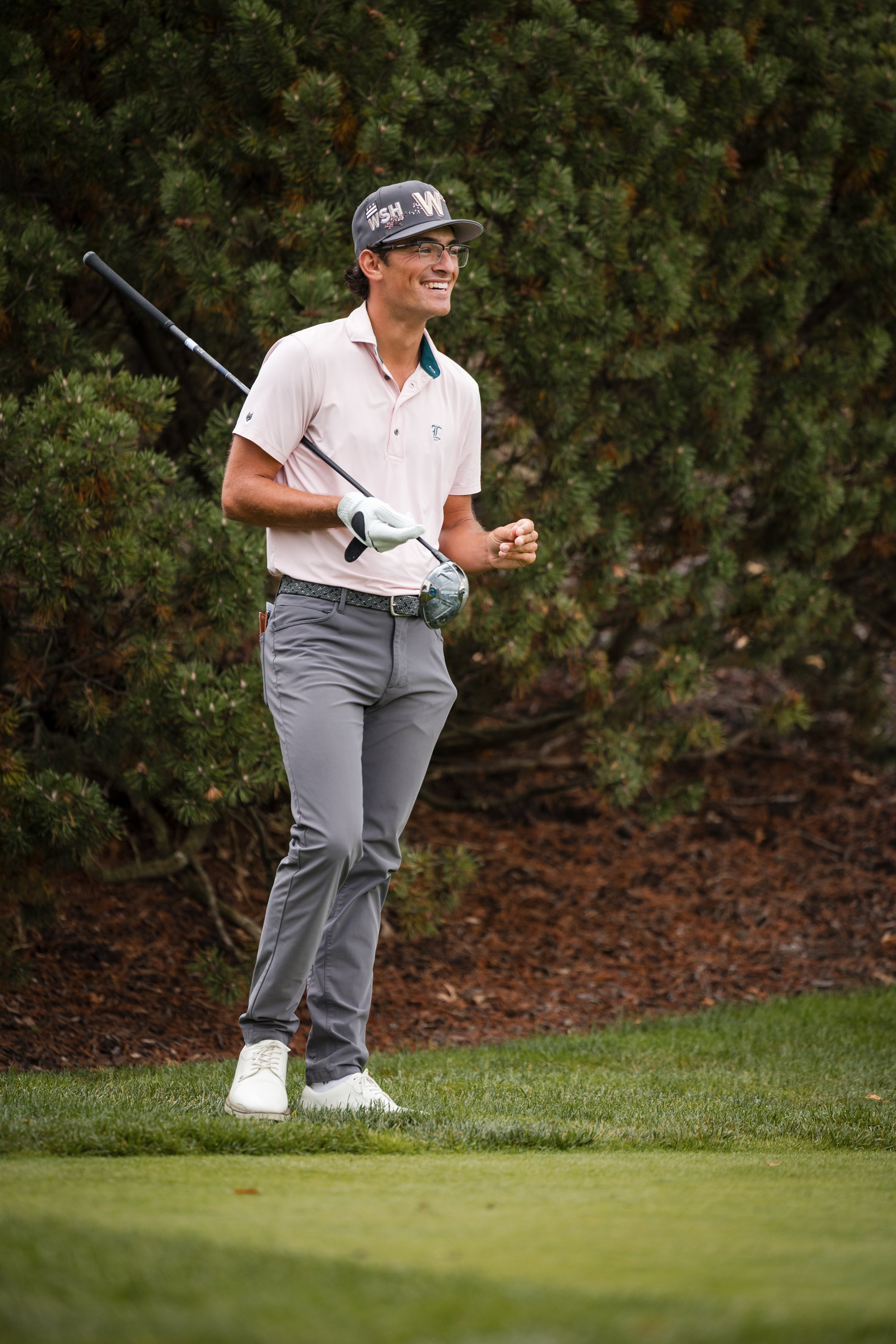 Back 9 Performance founder Amani D'Ambrosio with driver at golf club competing as performance coach