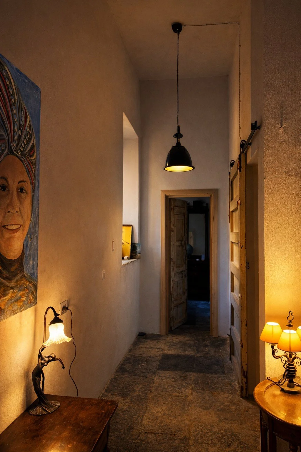 Warmly lit interior hallway at Tacasa in Riposto, Sicily.