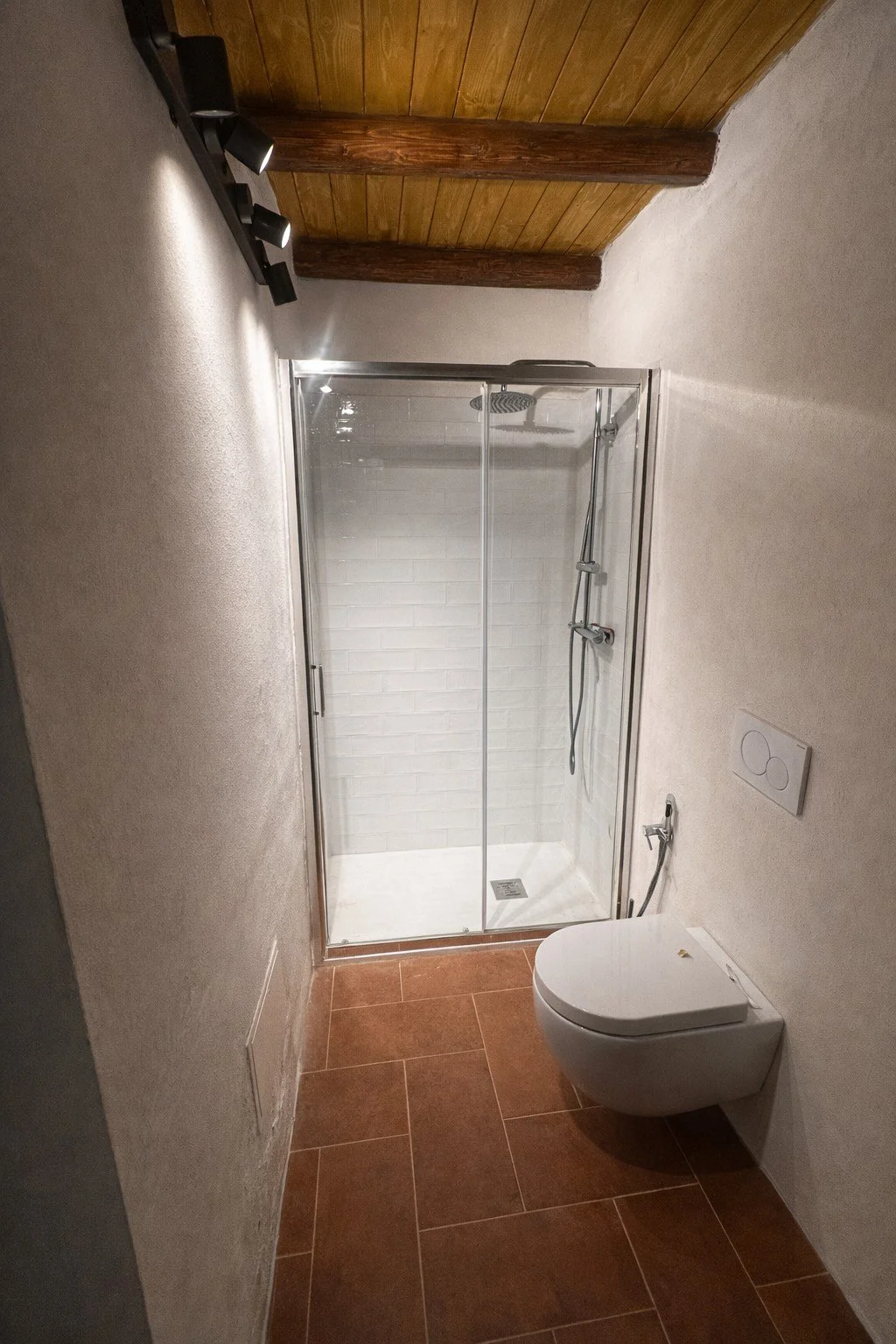 Modern bathroom with glass shower and natural materials at Tacasa in Riposto.