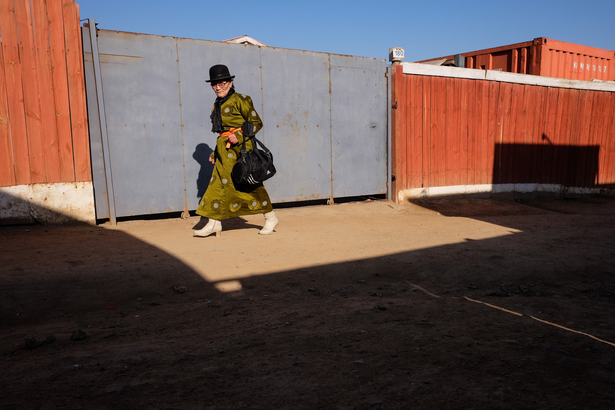 HG03 | woman crossing courtyard | mongolia | 2018