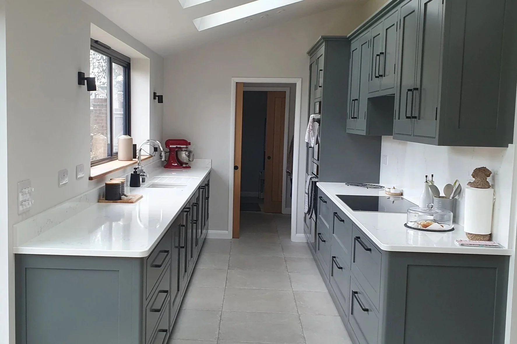 Modern dark grey kitchen with white stone worktops