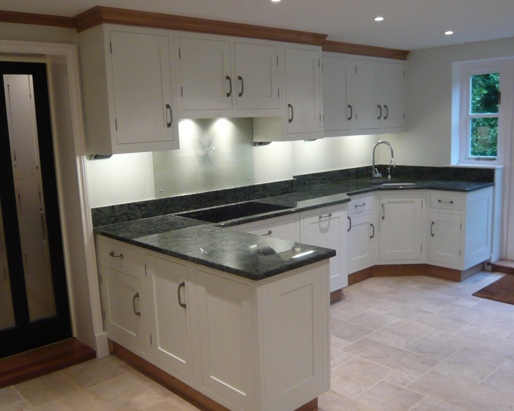 Traditional white painted units black granite worktops 