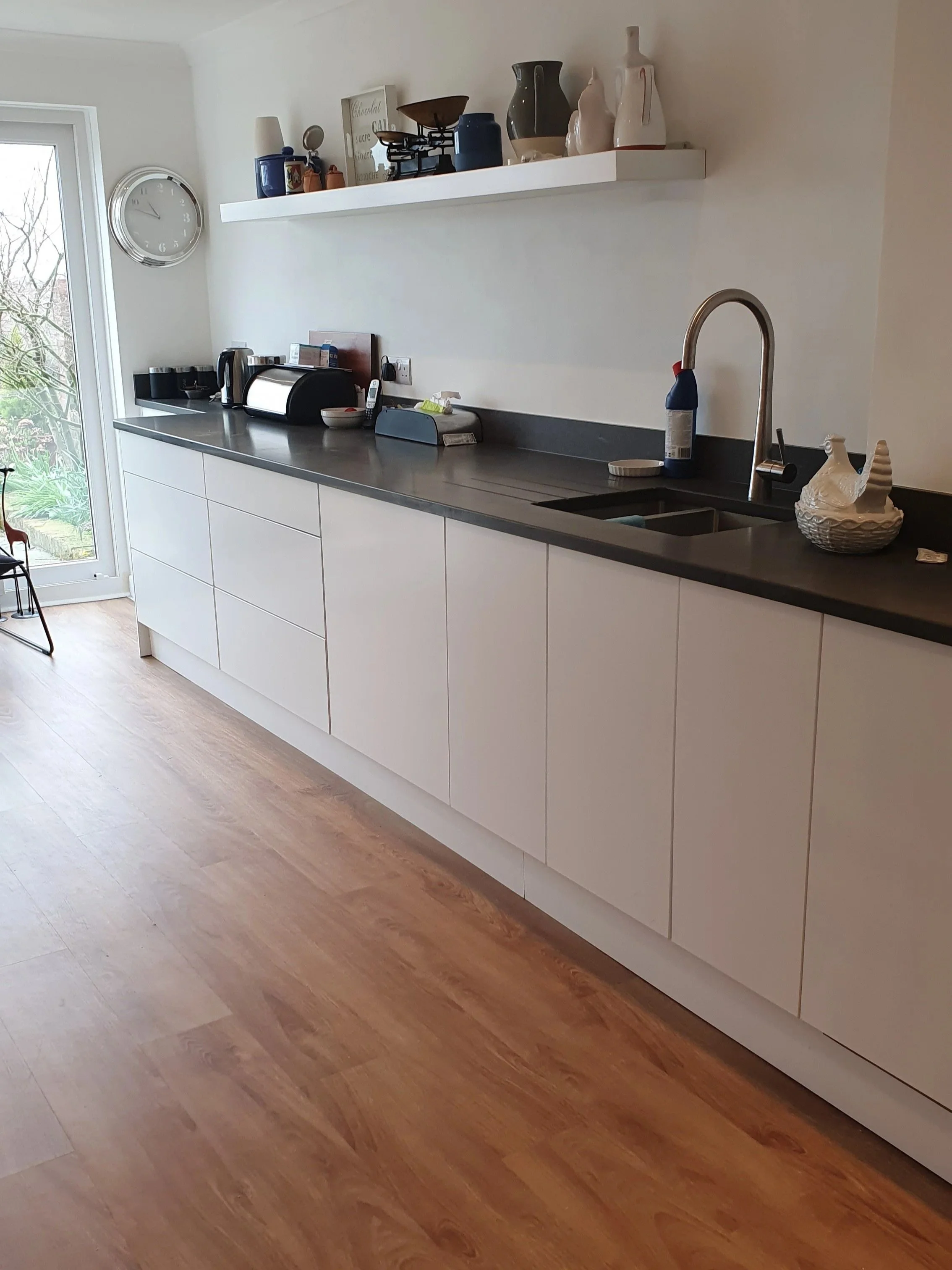 Modern white kitchen with black granite worktops
