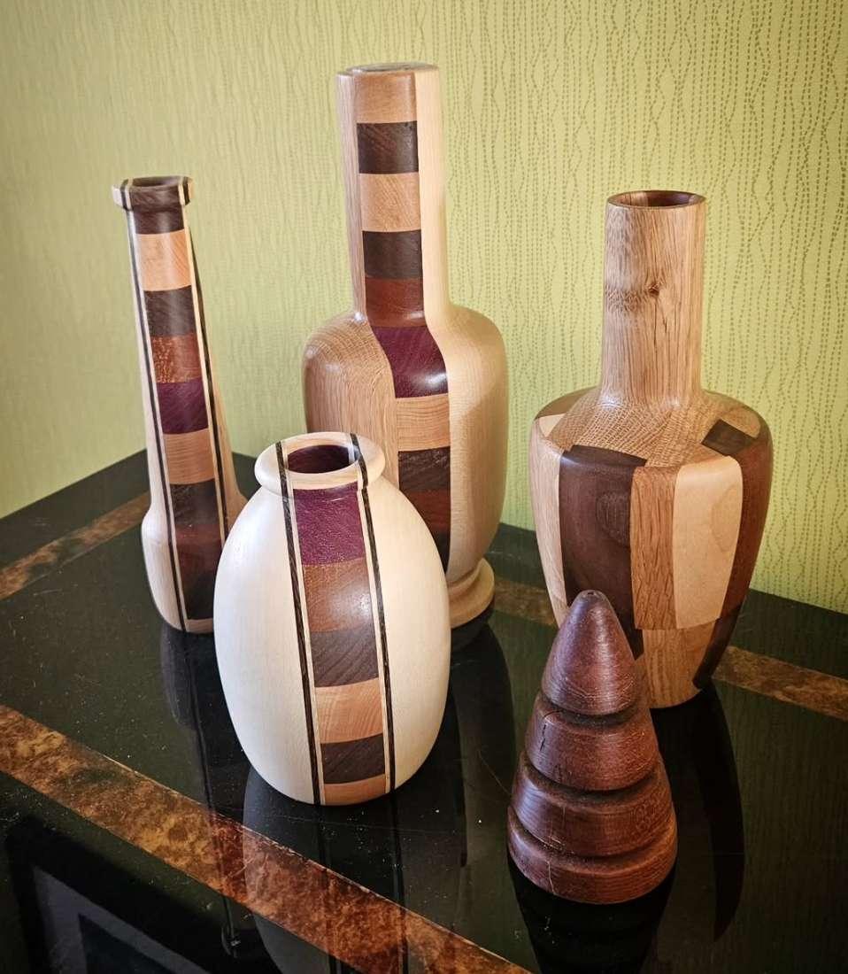 A Collection of hand-turned wooden vases in different coloured woods