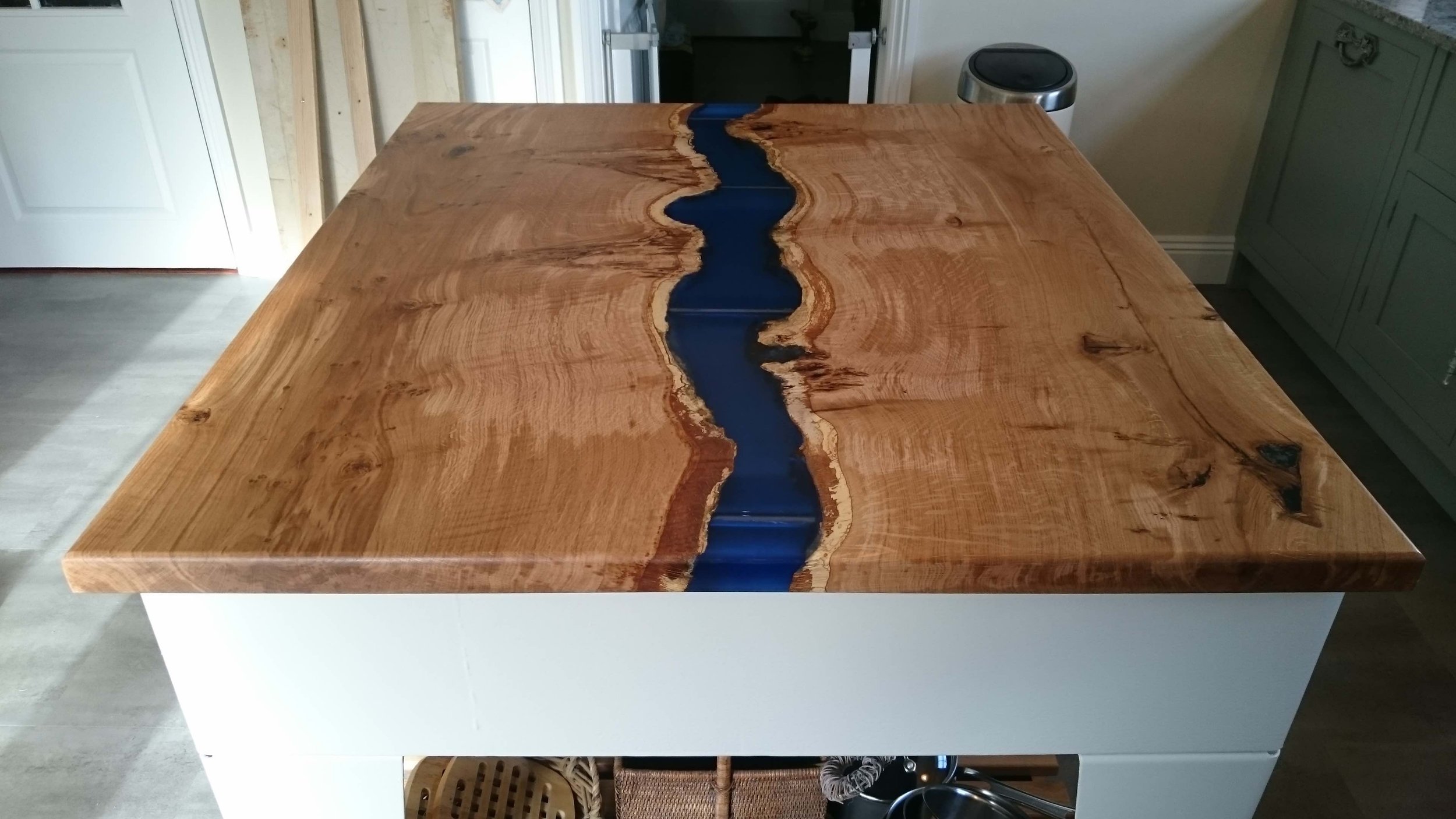 Metal based island with oak and resin river top