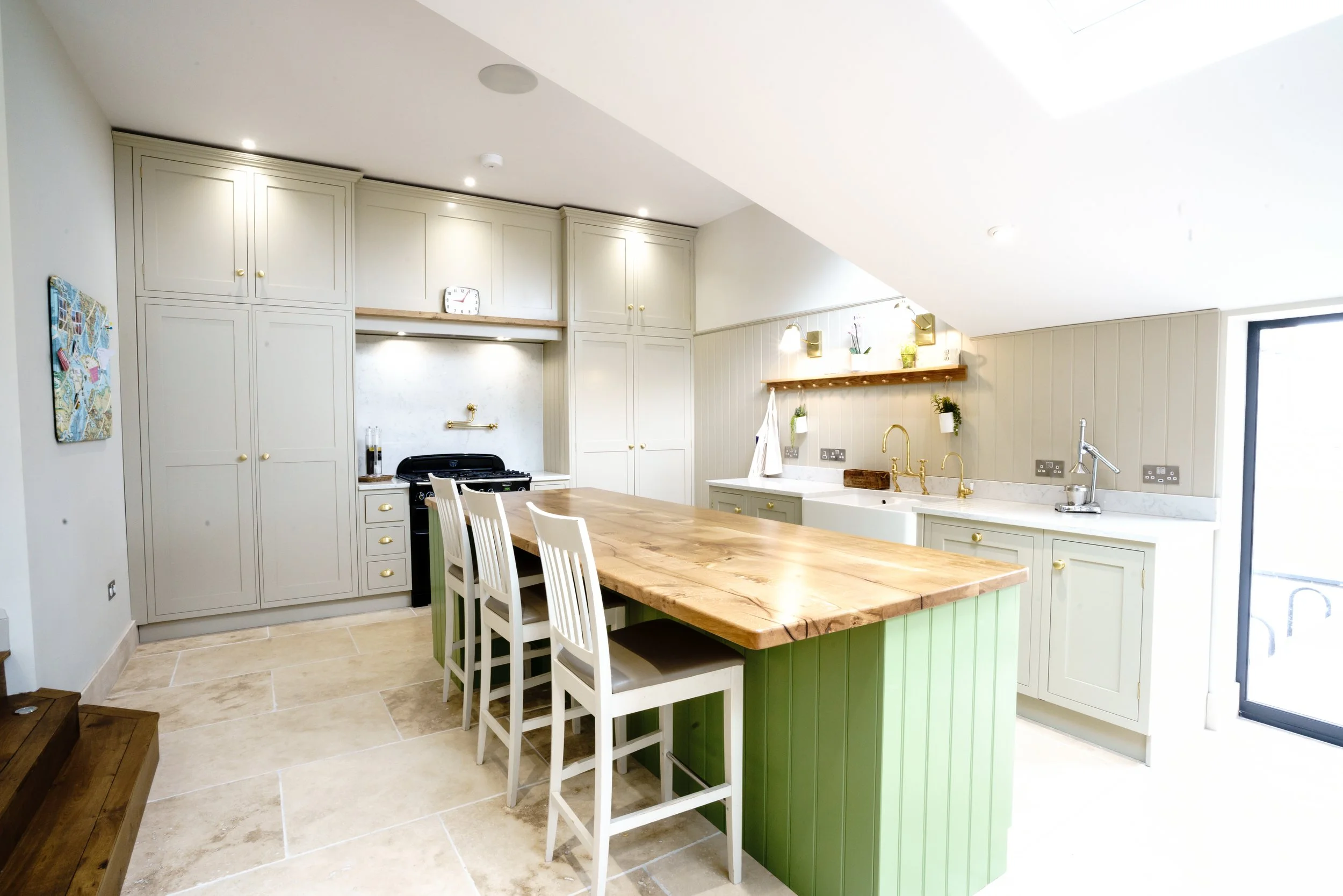 Large traditional painted kitchen with large green island and Oak worktop