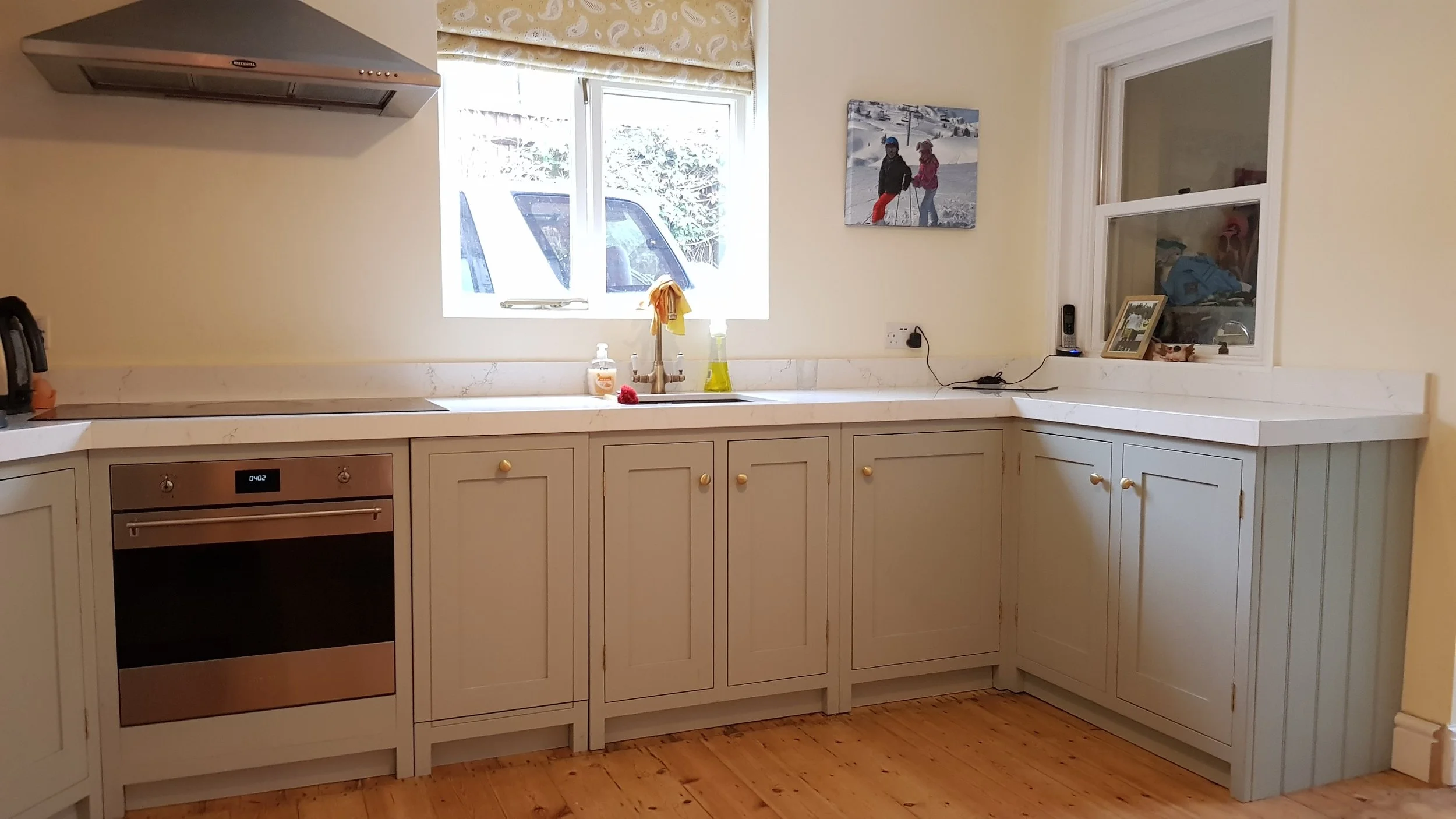 Traditional painted kitchen base units with white marble worktops