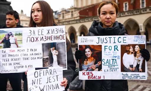 Members of the Kazakh diaspora and activists hold banners at a 'Justice for Saltanat' rally in Krakow, Poland, 21 April 2024. Photograph: Beata Zawrzel/NurPhoto/Getty Images
