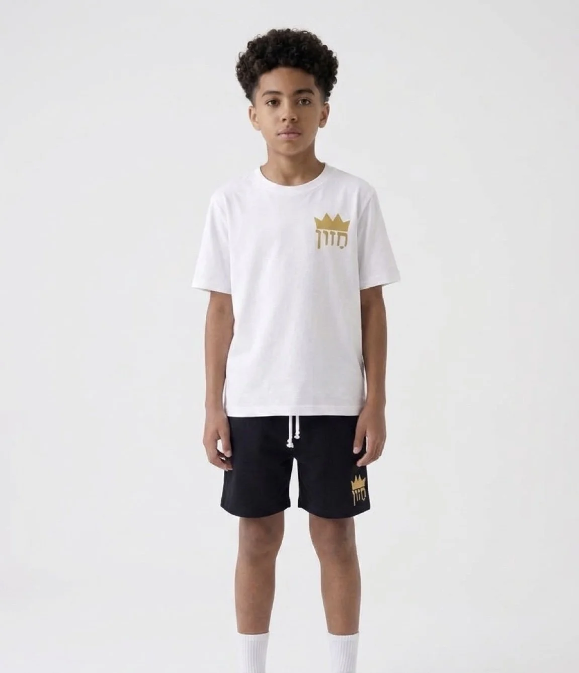 Boys white shirt, black shorts on model.jpg