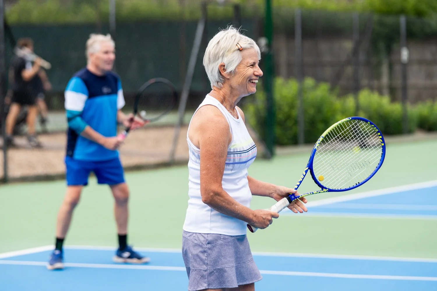 Female tennis player laughing and having fun