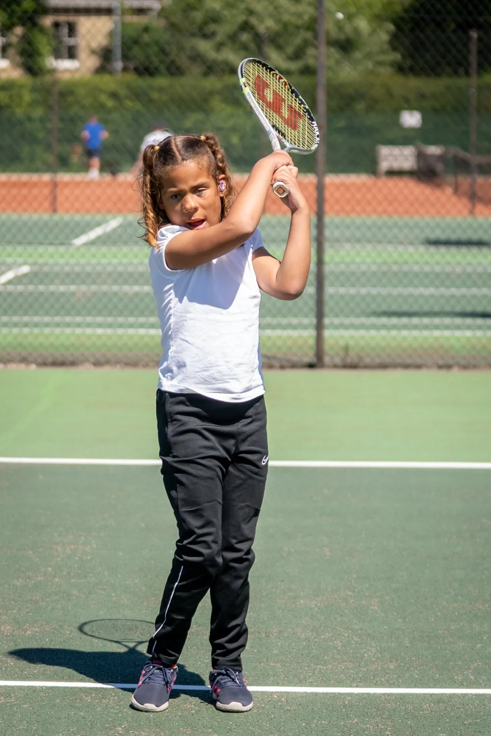 Junior player about to hit a tennis ball
