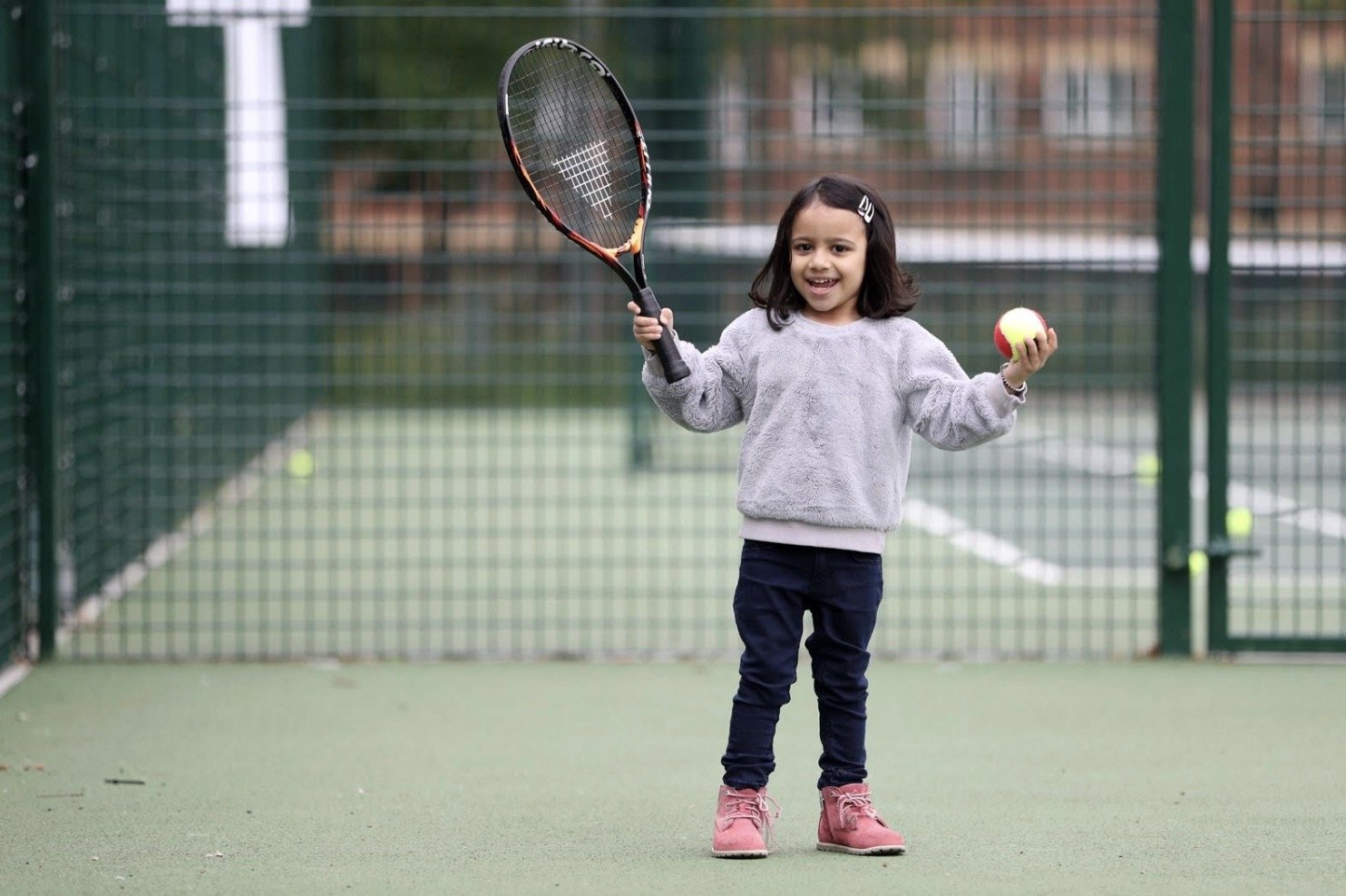 Young player holding a racket and a ball