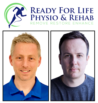 A photo of mike and his colleague smiling at the camera, on a plain background