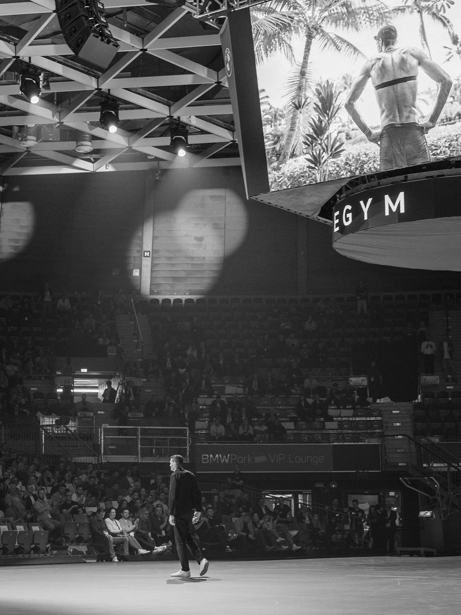 Jan Frodeno addressing a large crowd at a keynote speech in Munich, Germany.