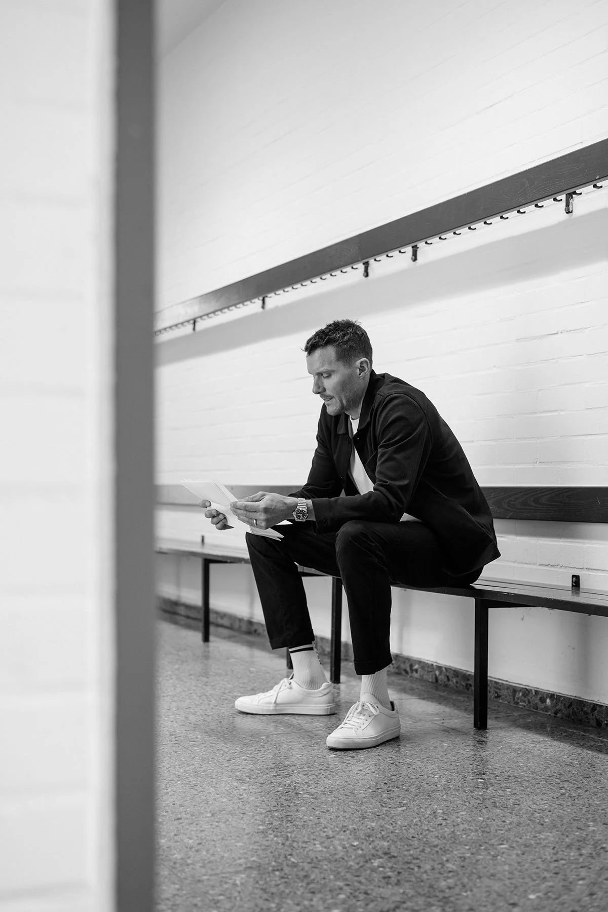 Jan Frodeno sitting on a bench, preparing for a keynote speech