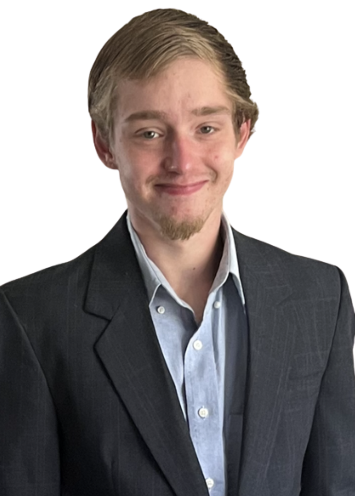 A young man in a black suit with a light blue shirt, smiling, with a neutral background.