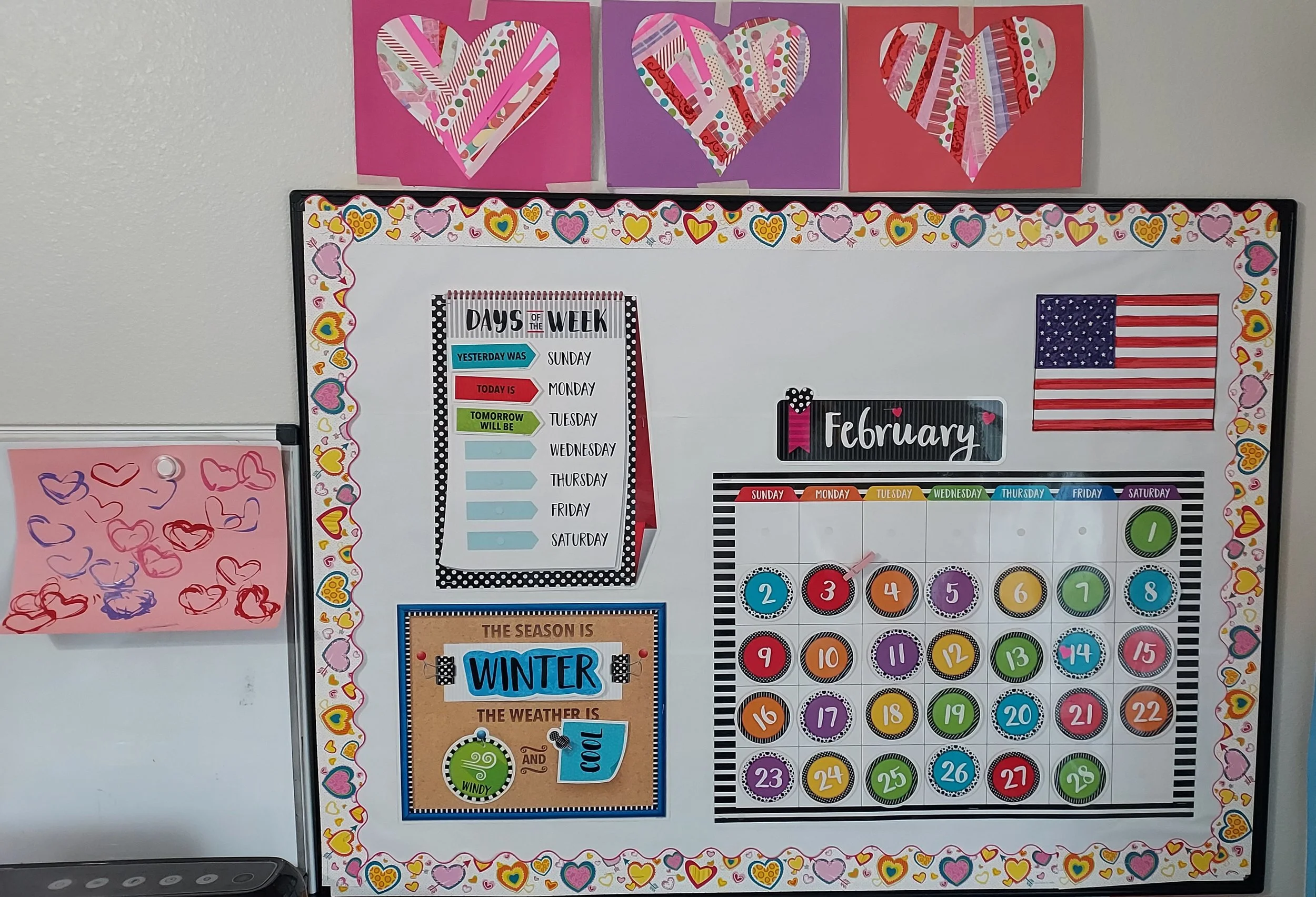 February classroom calendar with a heart-themed border, American flag, and colorful calendar dates. Art with hearts and a weather season sign.