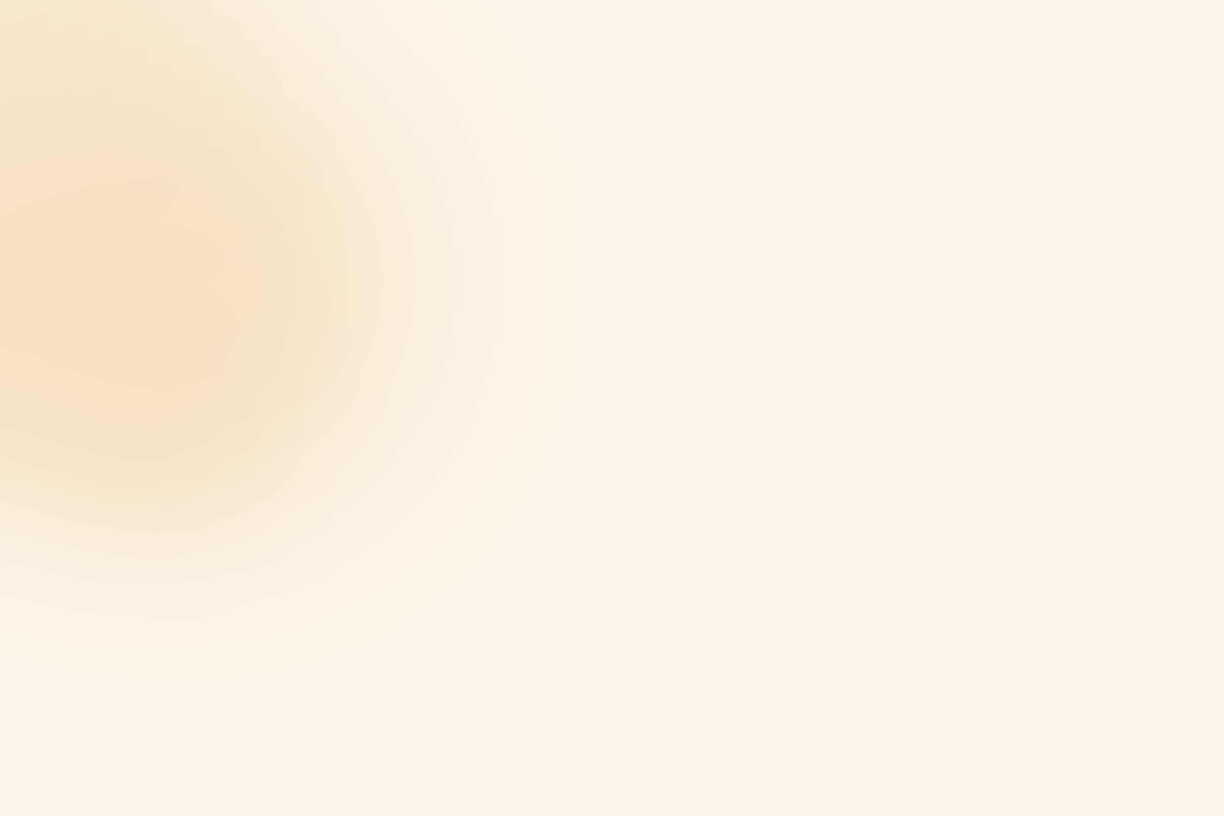 A blurred image with a gradient of soft beige tones.