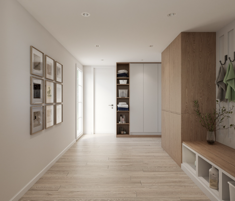 Minimalist entryway with framed photographs on the wall, a wooden storage unit with open shelves and a white cabinet, a vase with branches on a bench, and coats on hooks.