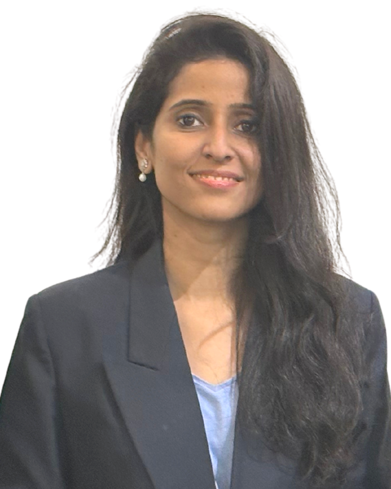 A woman with long, wavy black hair, wearing a black blazer and pearl earrings, smiling in a professional setting. India and Canada. Wedding Planner