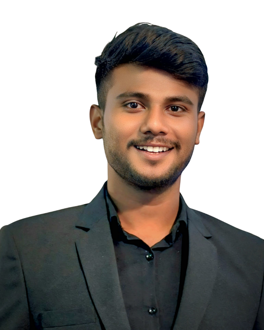 A young man with dark hair, a beard, and a smile, wearing a black shirt and a dark blazer. India and Canada
