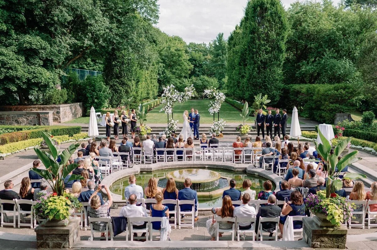 Outdoor garden wedding ceremony at Graydon Hall Manor Toronto with elegant floral mandap design.