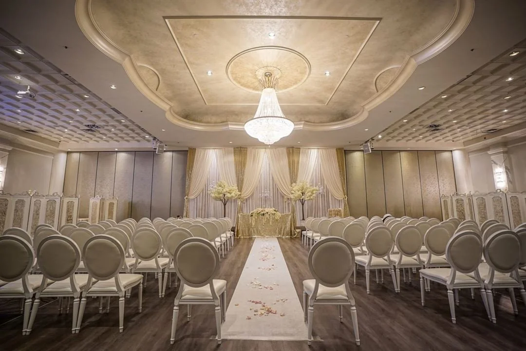 Large scale Indian wedding reception decor with crystal chandeliers at Mississauga Convention Centre.