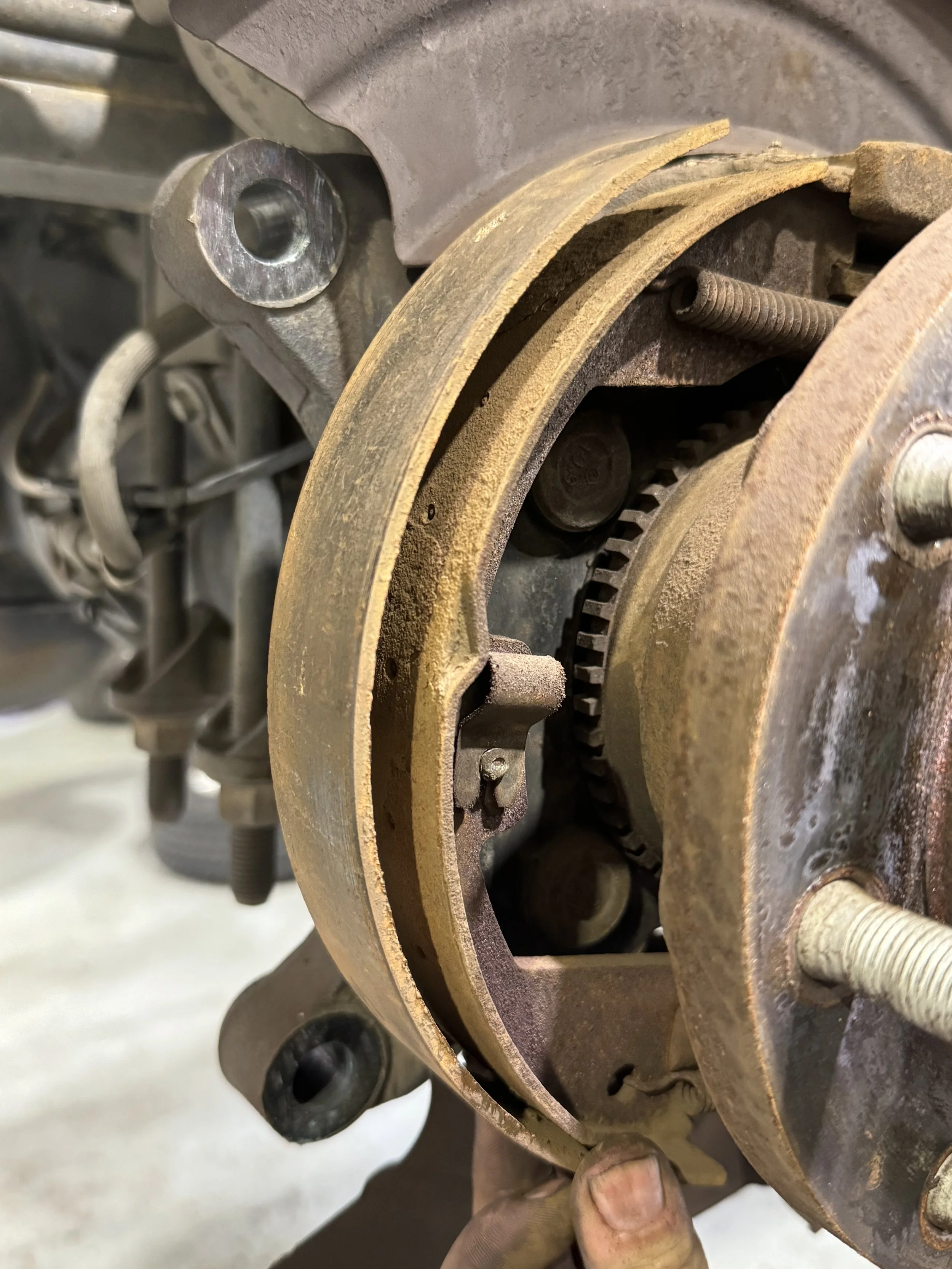 Close-up of heavily rusted and worn drum brakes that were professionally replaced at Black Bear Auto Service in Burnaby, BC