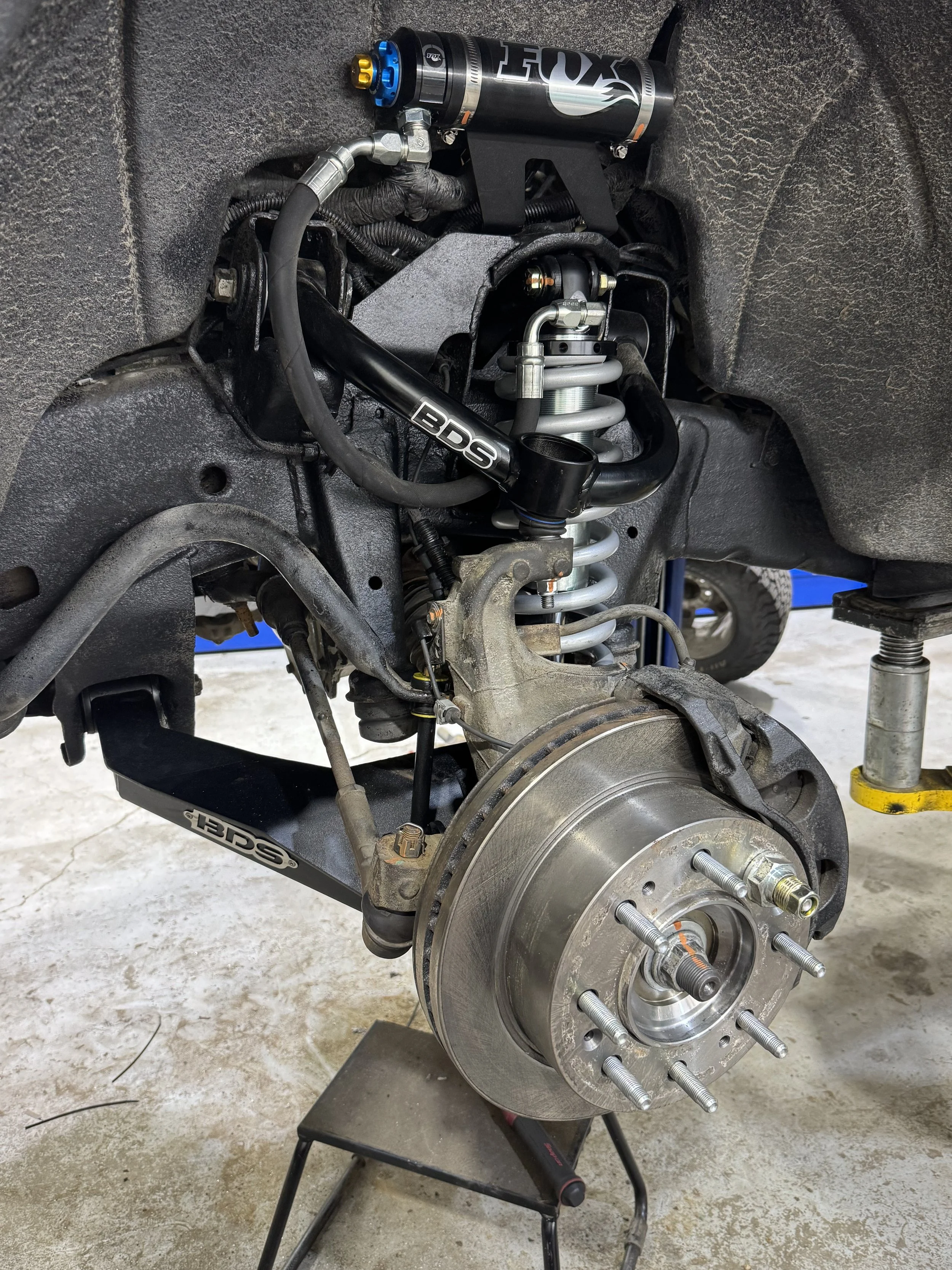 Close-up of a truck’s suspension system with aftermarket control arms and upgraded suspension components professionally installed at Black Bear Auto Service in Burnaby, BC