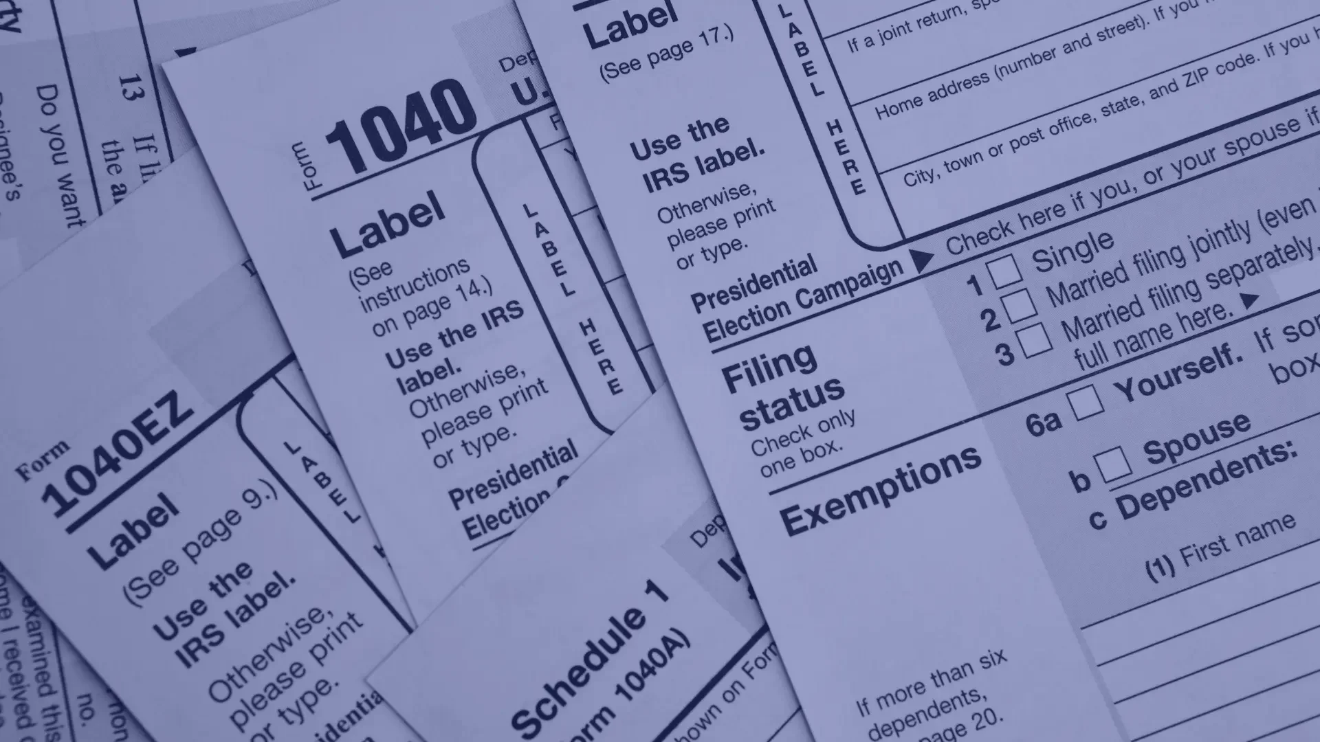 Multiple pages of IRS tax forms (1040) with sections for filing status and exemptions, partially overlapping, printed in black ink on white paper.