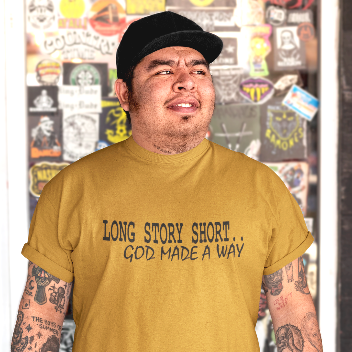 tee-mockup-of-a-man-with-tattooed-arms-posing-by-a-glass-door-32856.png