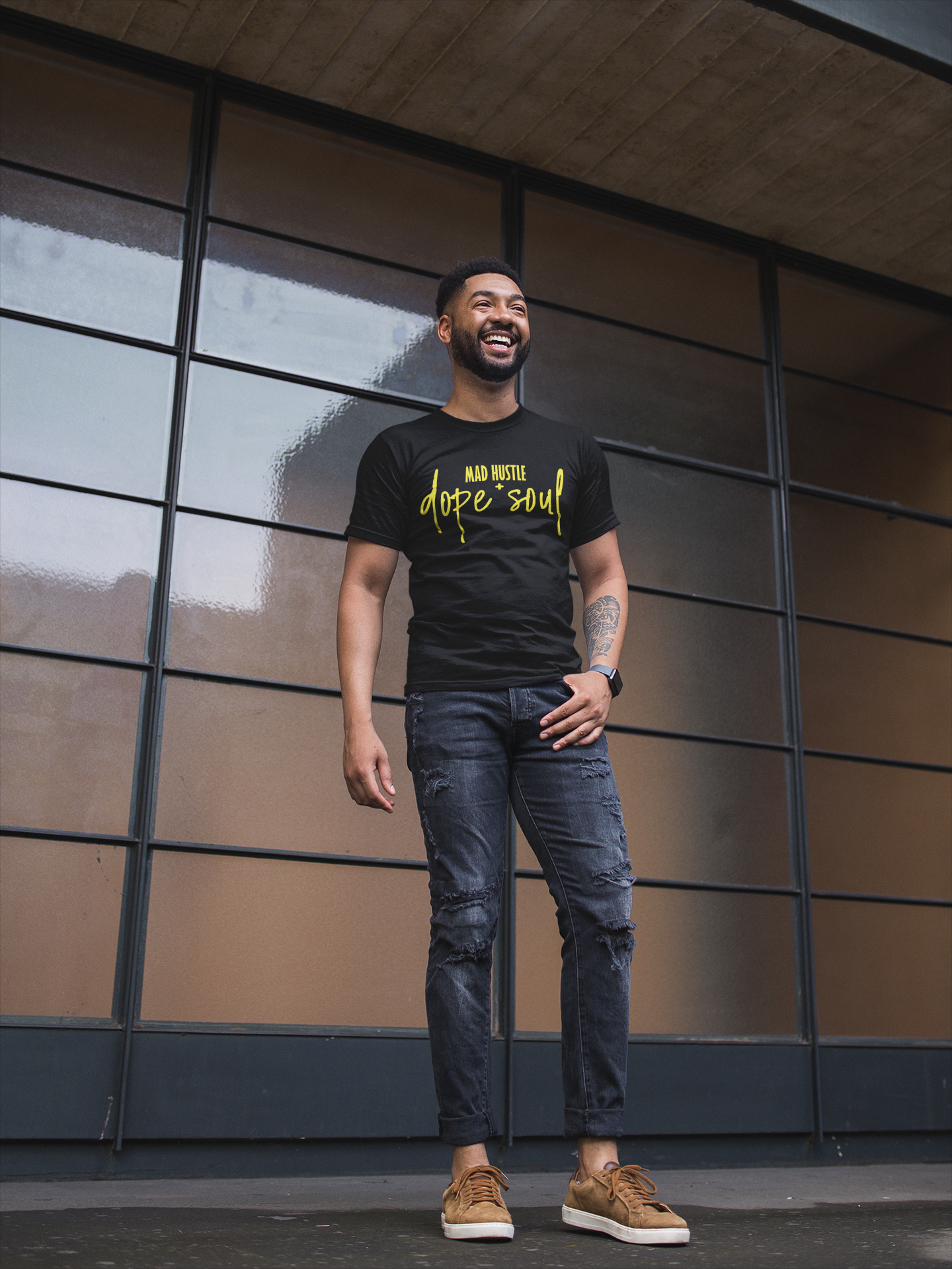 t-shirt-mockup-of-a-stylish-man-smiling-in-front-of-a-window-wall-21348.png