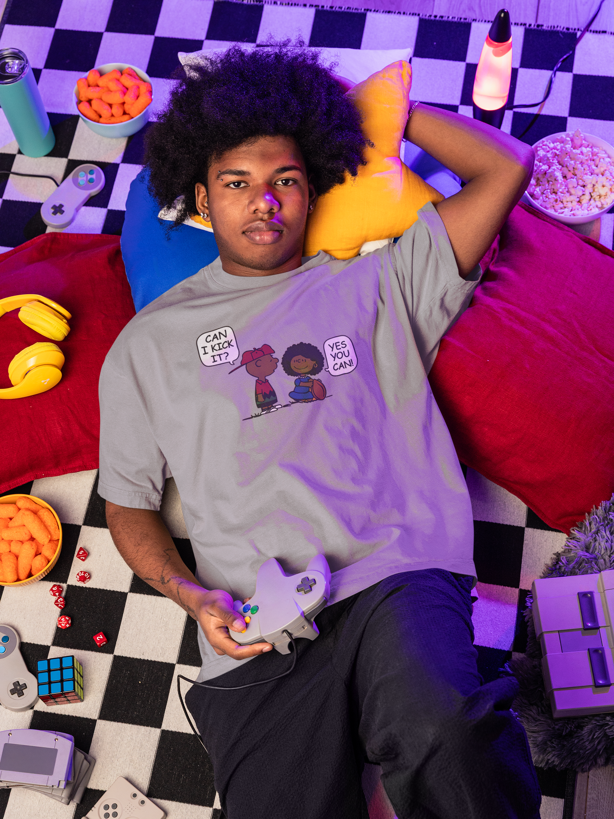 oversized-t-shirt-mockup-featuring-a-serious-man-relaxing-on-the-floor-with-gaming-stuff-m56635.png
