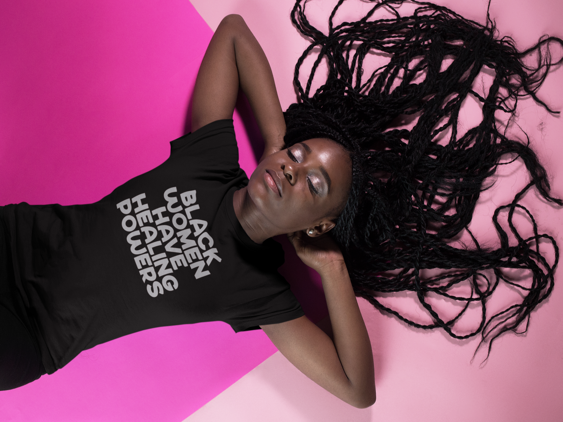 mockup-of-a-woman-wearing-a-t-shirt-template-while-lying-on-a-pink-surface-17185.png
