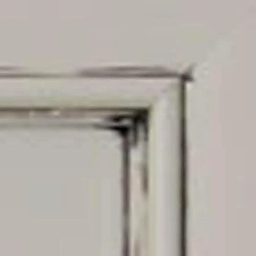 Close-up of a white door corner with a small shadow in the corner.