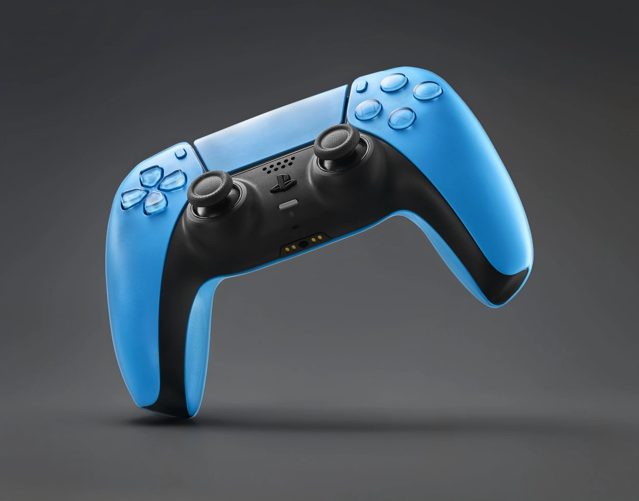 A gaming controller with blue and black design, featuring dual joystick controls, action buttons, and a light bar on a gray background.