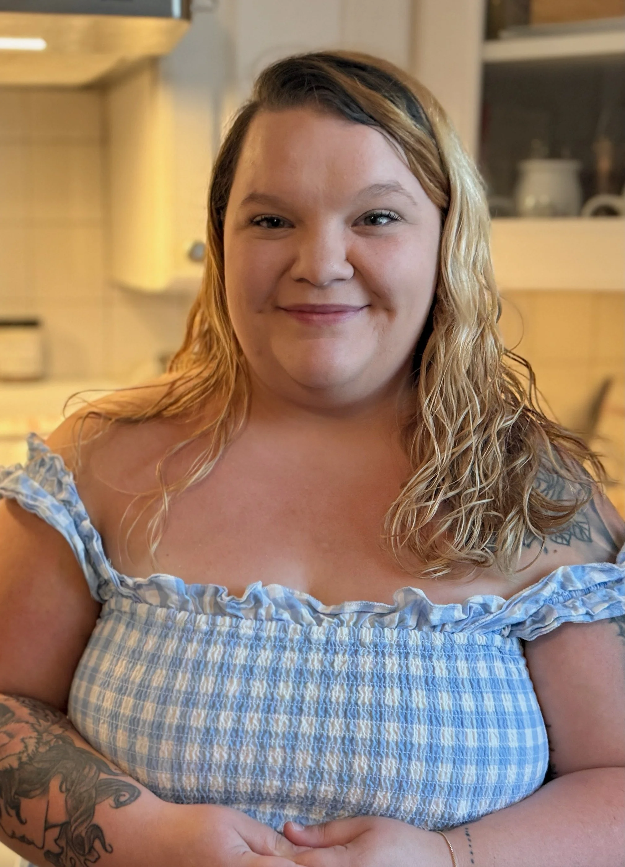 Autumn, founder of Autumn's Donuts, standing in her kitchen