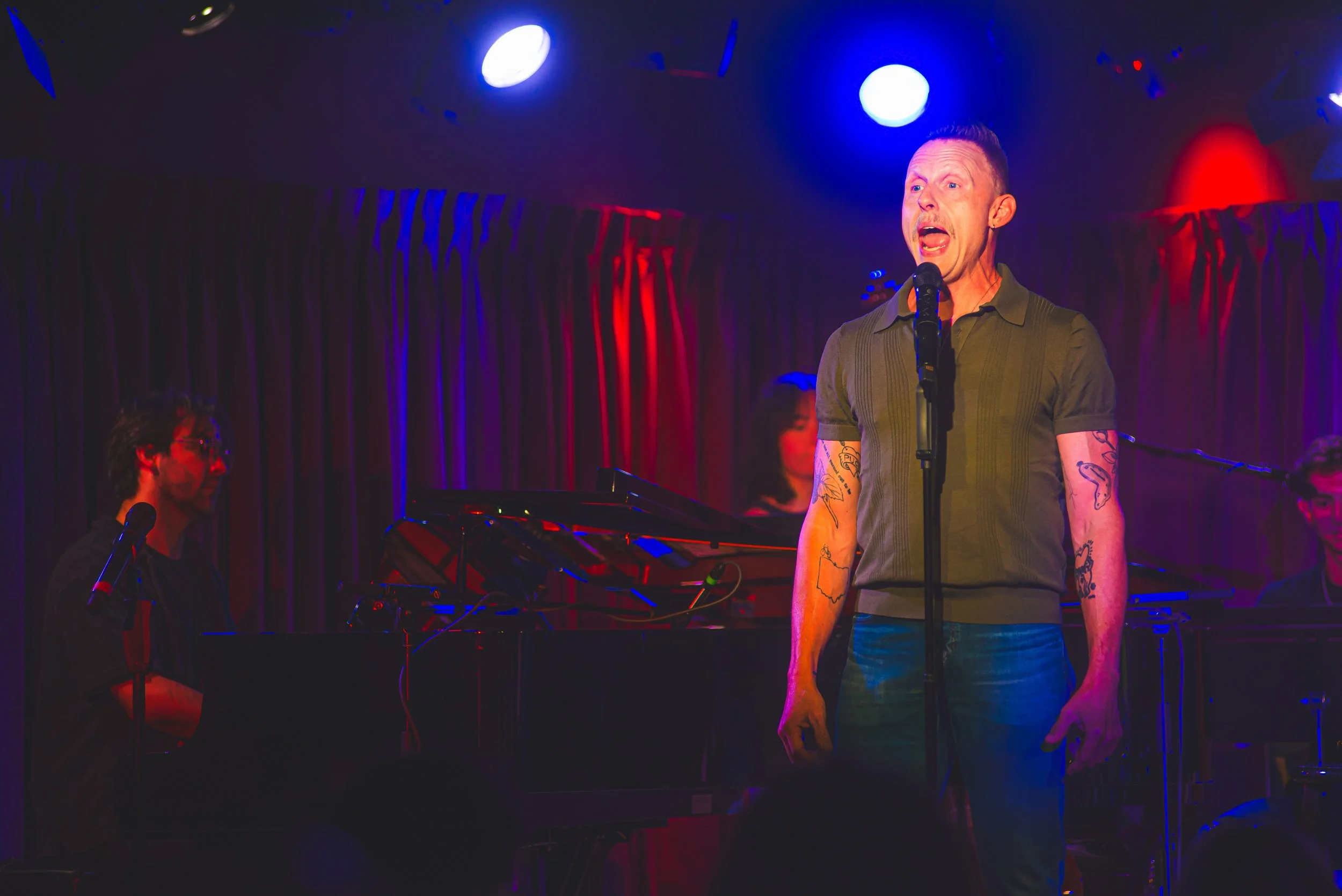 David singing at Greenroom 42 with a band in the show "Being Alive," a tribute to Larry Kert. 