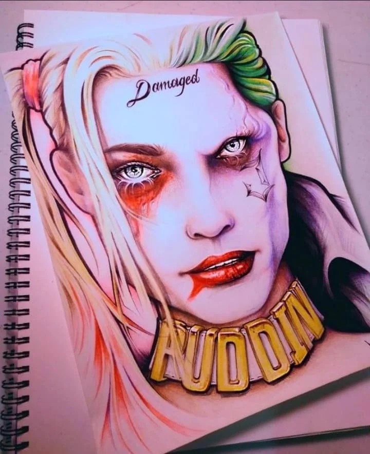 Colorful portrait of Jared Leto as Harley Quinn with damaged makeup and a 'JUDDIN' necklace, with the word 'Damaged' written on forehead.