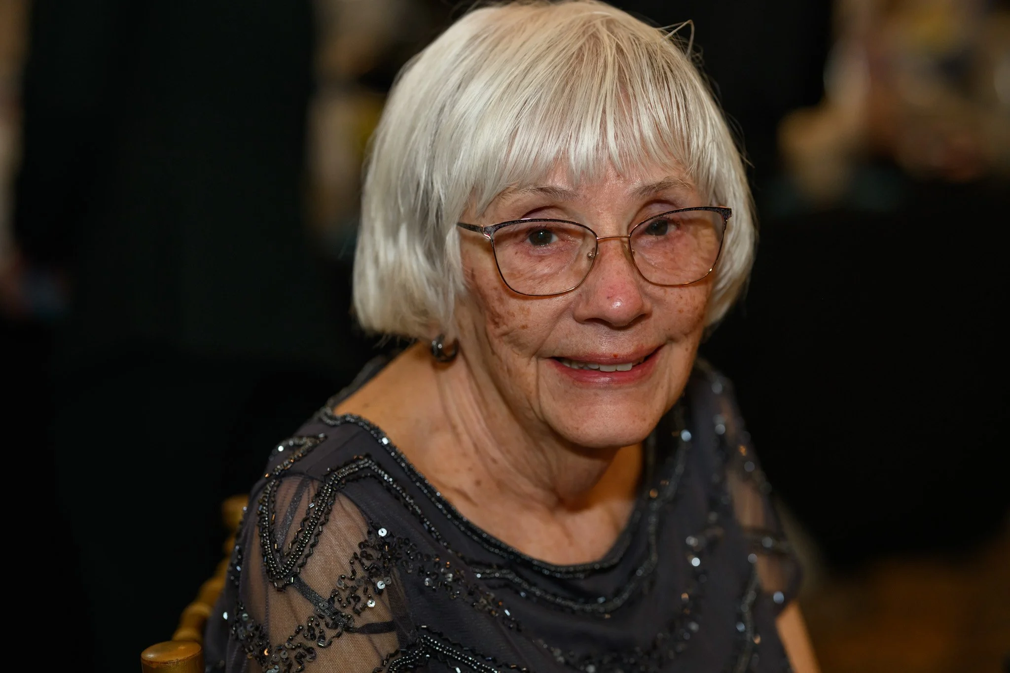 2026 Gala Woman with white hair and glasses smiling.jpg