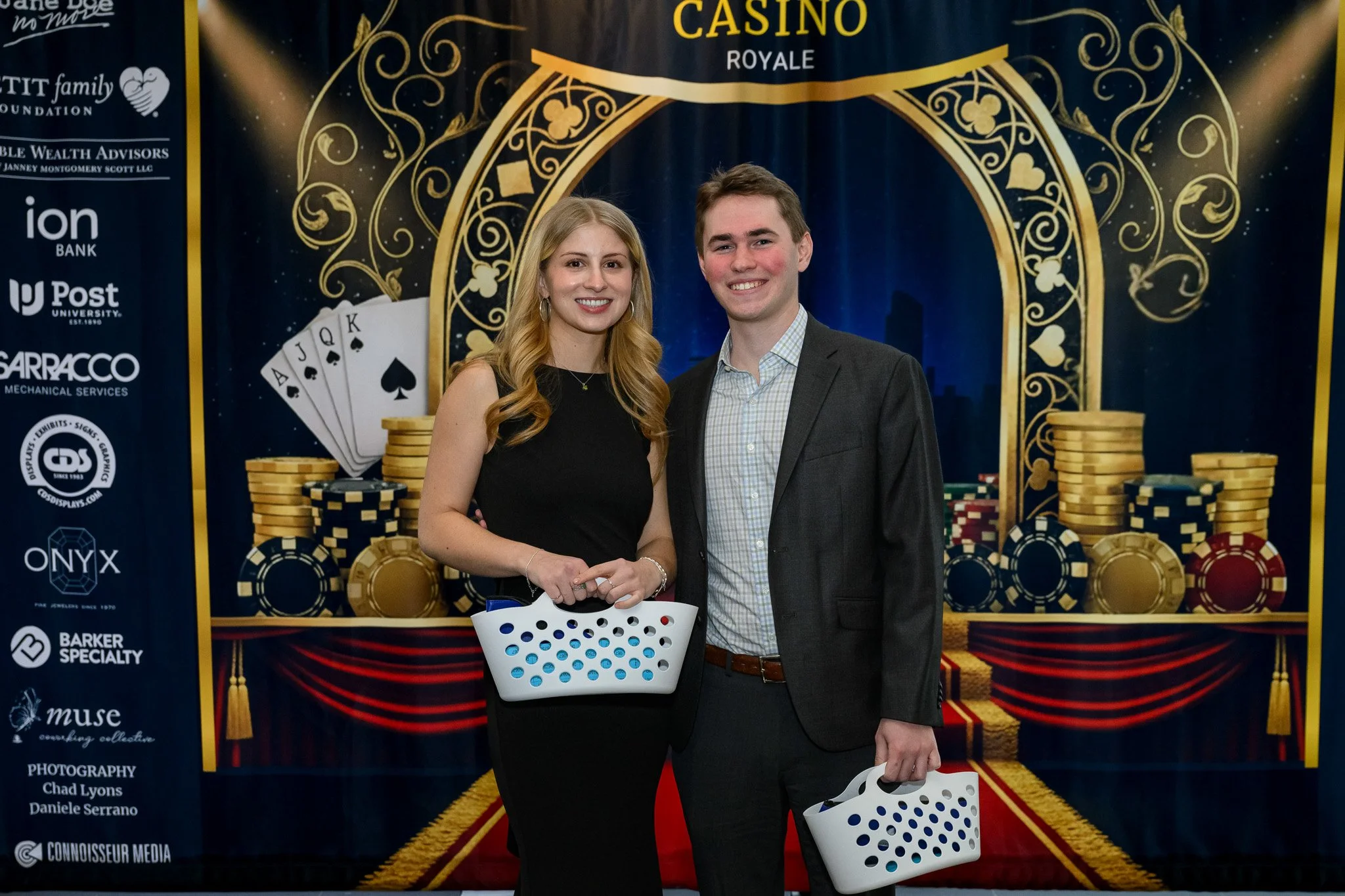 2026 Gala two young volunteers holding raffle baskets.jpg