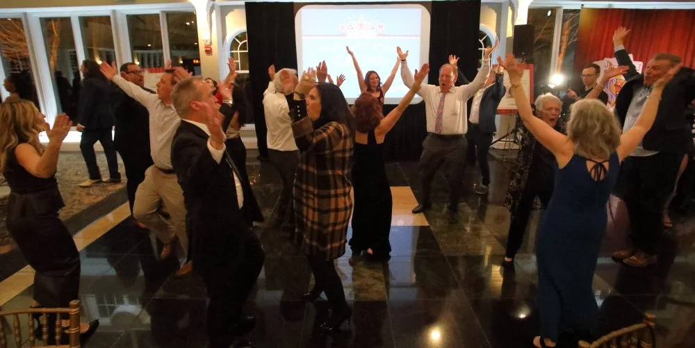 2026 Gala large group dancing hands in the air.JPG