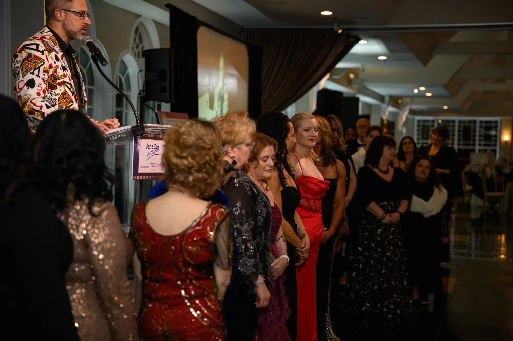 2026 Gala Survivors in front of stage Troy at podium.jpg