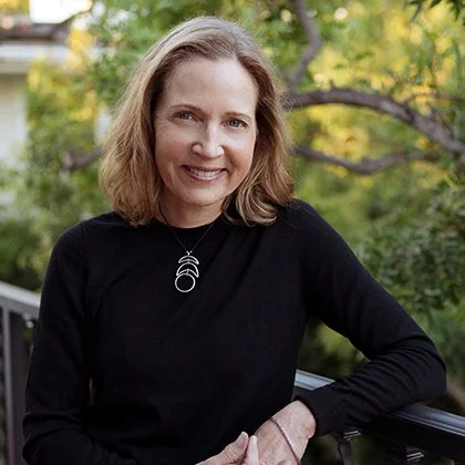 Headshot of Caroline Welch outdoors in front of trees