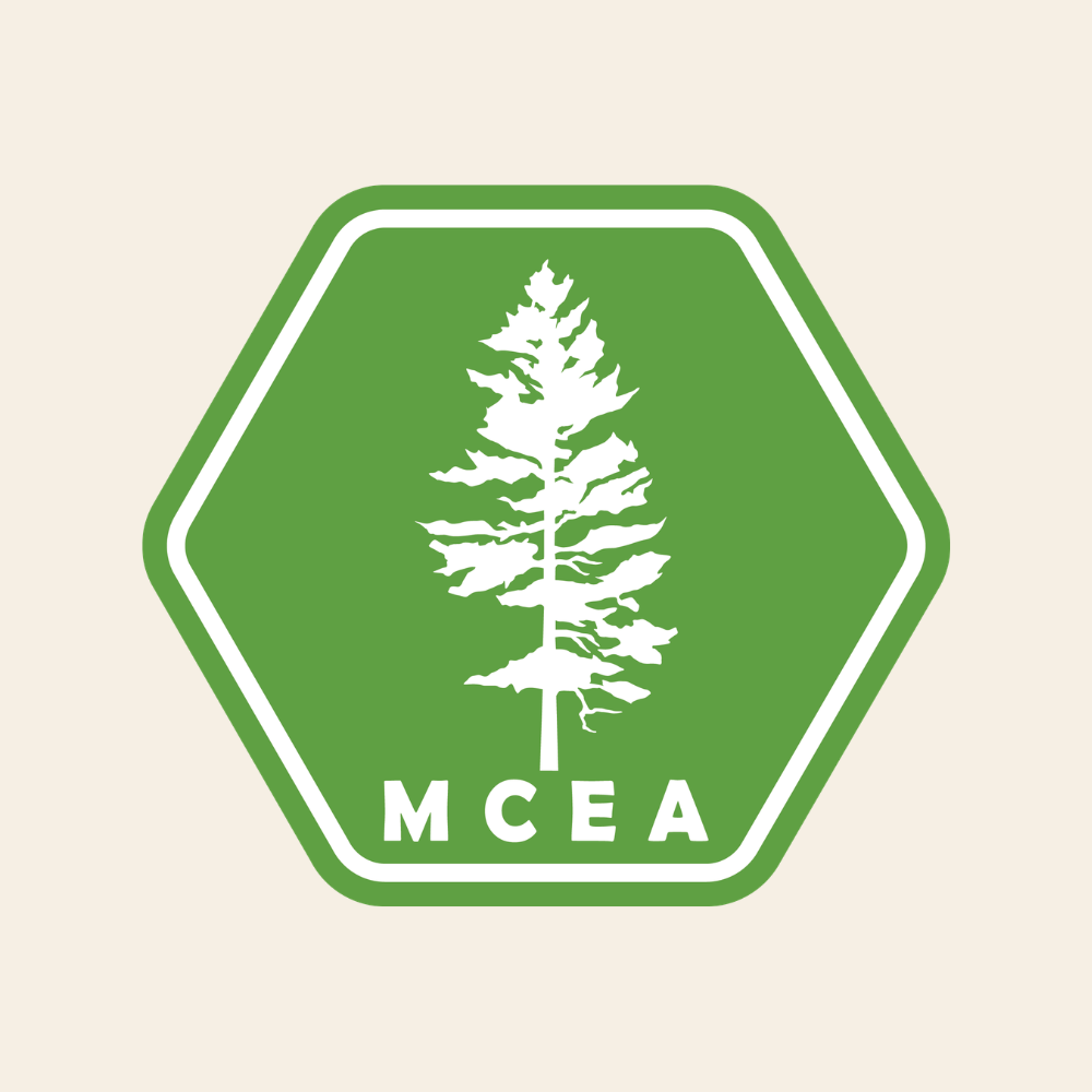 Green hexagonal logo with a white pine tree and the letters MCEA underneath.