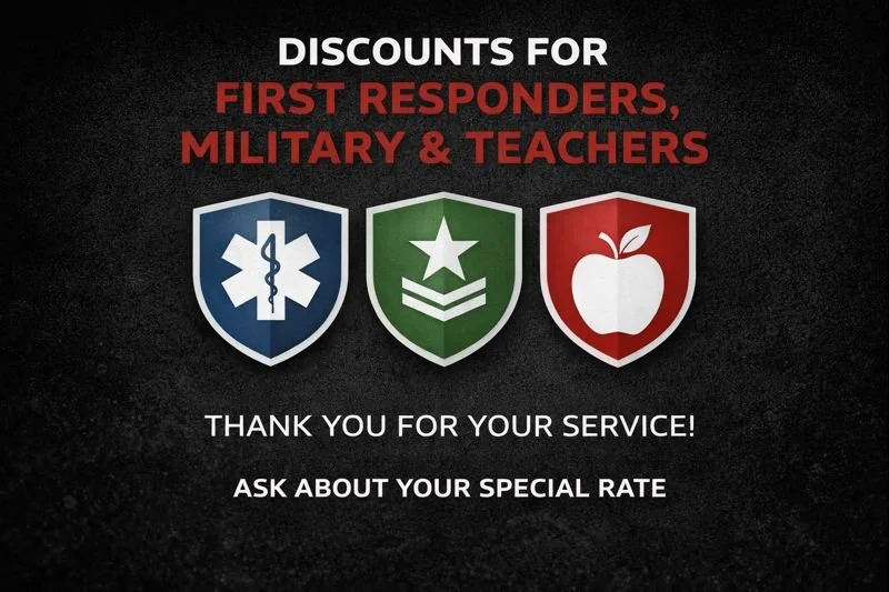 Sign offering discounts to first responders, military personnel, and teachers, with icons of a medical shield, a military badge, and an apple on shields, and text expressing gratitude and asking about a special rate.