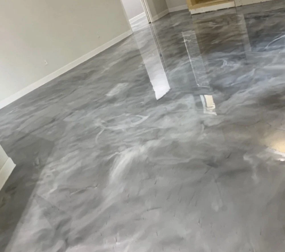 Clean, polished marble flooring in an empty room with a door at the back.