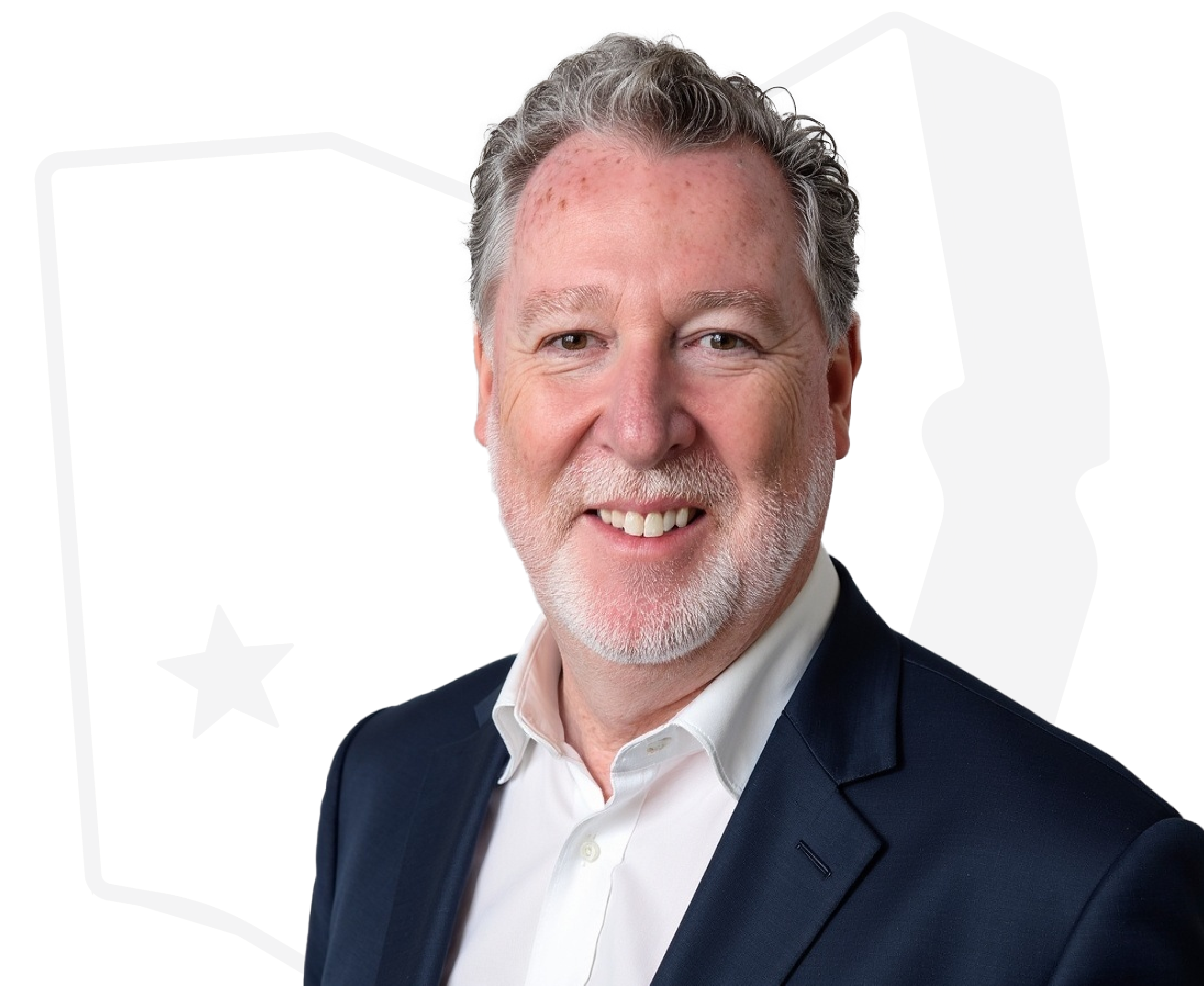 A middle-aged man with gray hair and a beard, wearing a white shirt and a dark blazer, smiling at the camera.