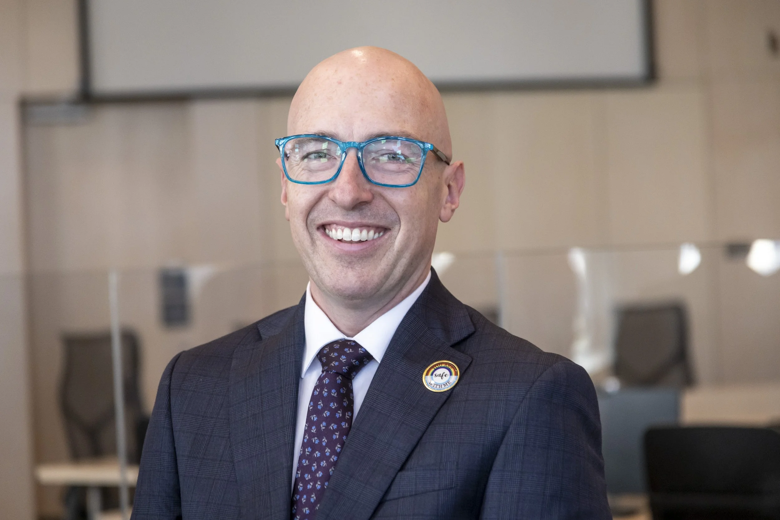 Andrew Knack, Mayor of Edmonton, wearing a suit and smiling in an office setting.