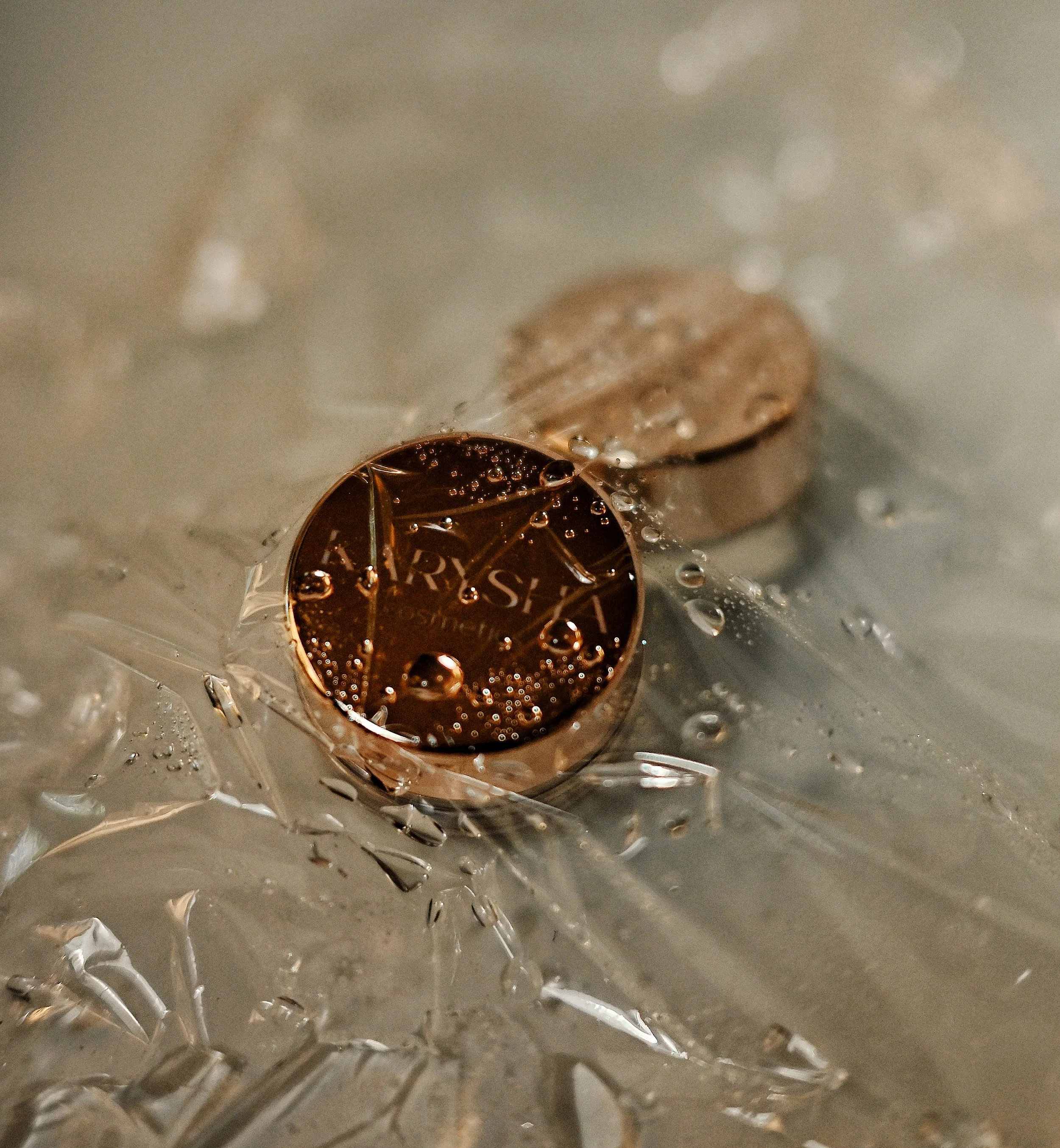 Close-up of a champagne cork with the words "BARYSH" visible, partially covered by broken glass and bubbles, indicatingchampagne or sparkling wine in a celebratory setting.